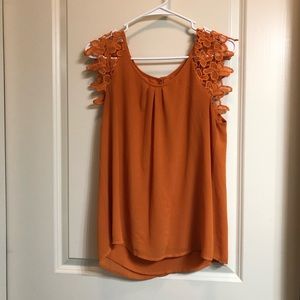 Orange lace detail shirt.
